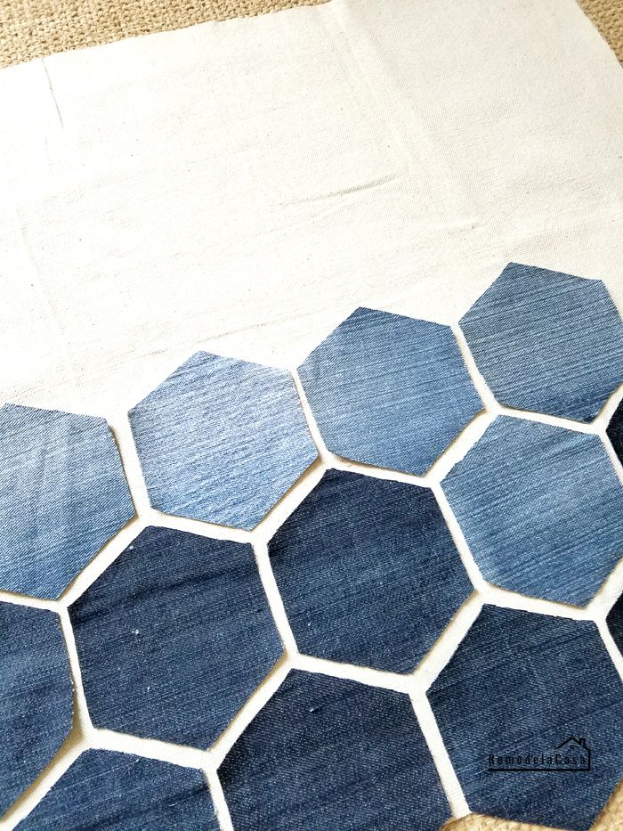 blue and white hexagon tiles laid out on the floor with one piece missing