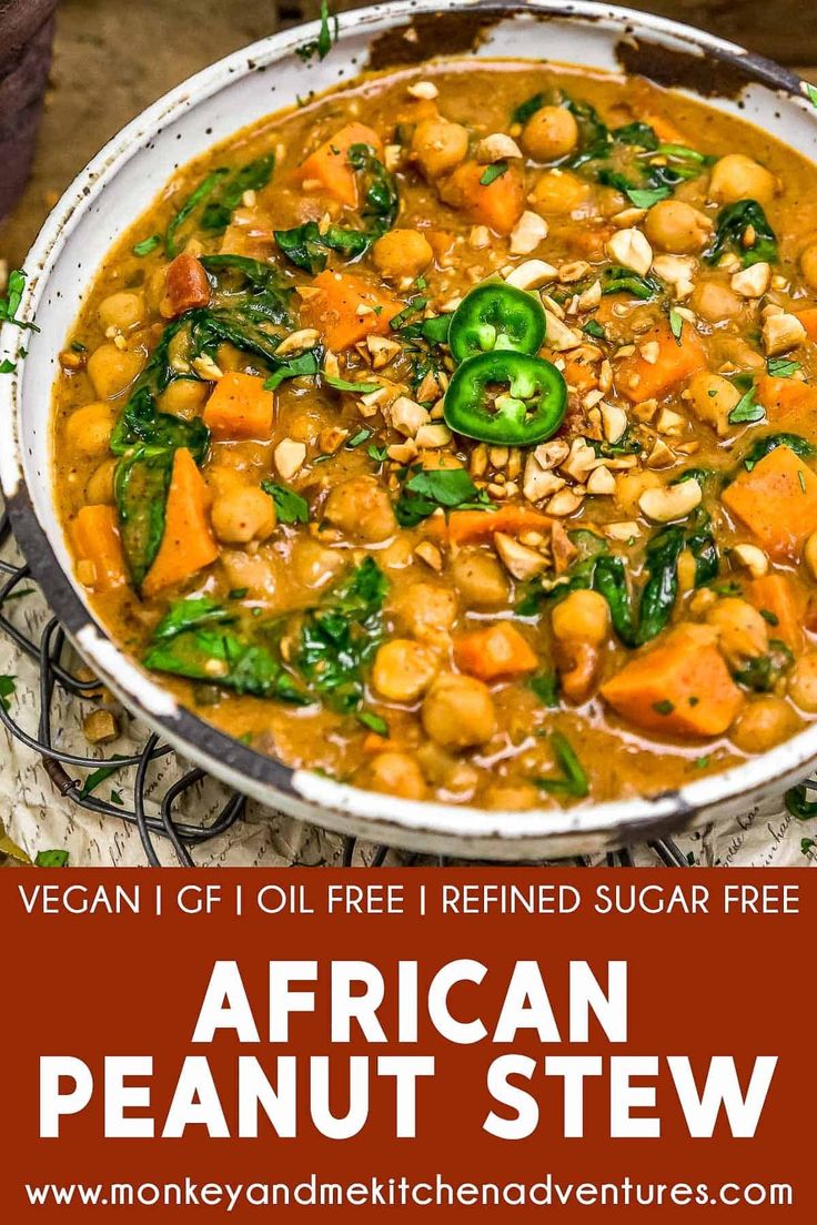 a bowl of african peanut stew with spinach and carrots