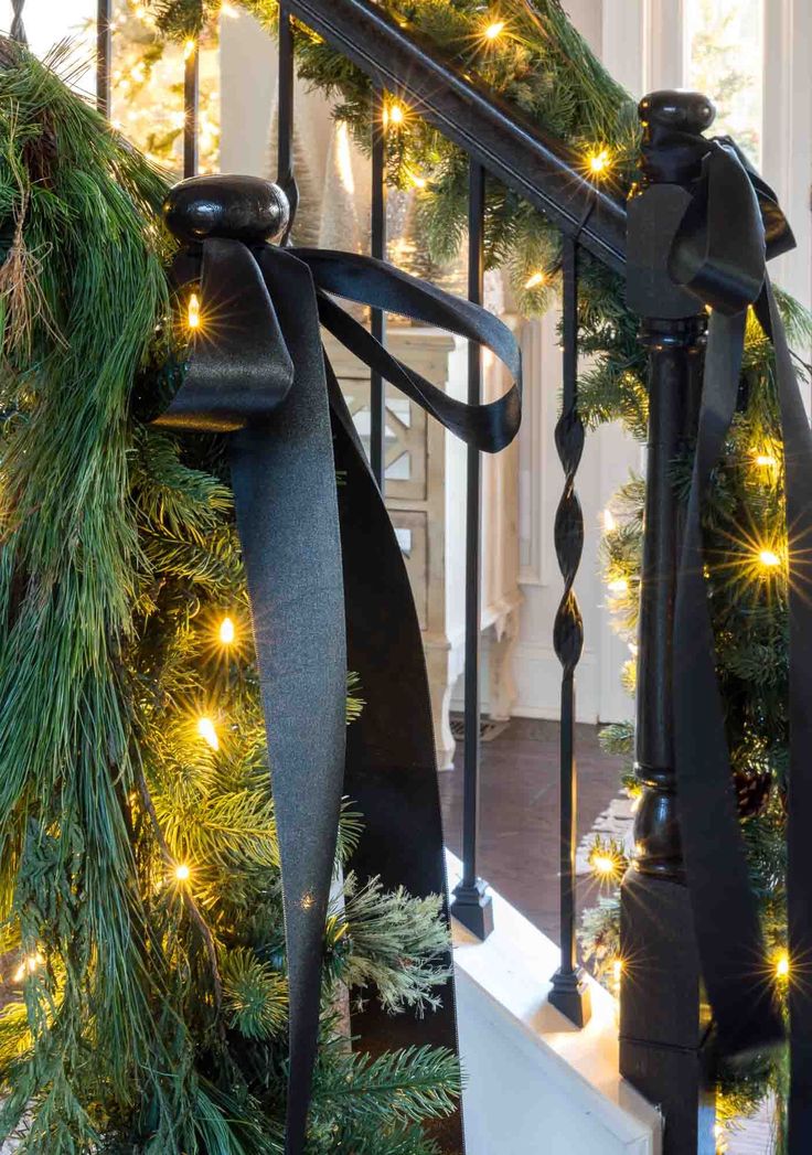 christmas garland with lights and bells on the banister