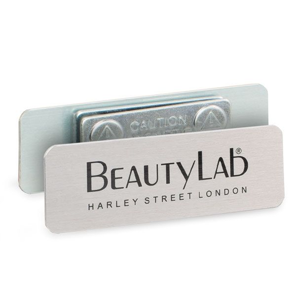 a metal business card holder with the word beauty lab on it's front and bottom