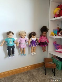 several dolls are hanging on the wall