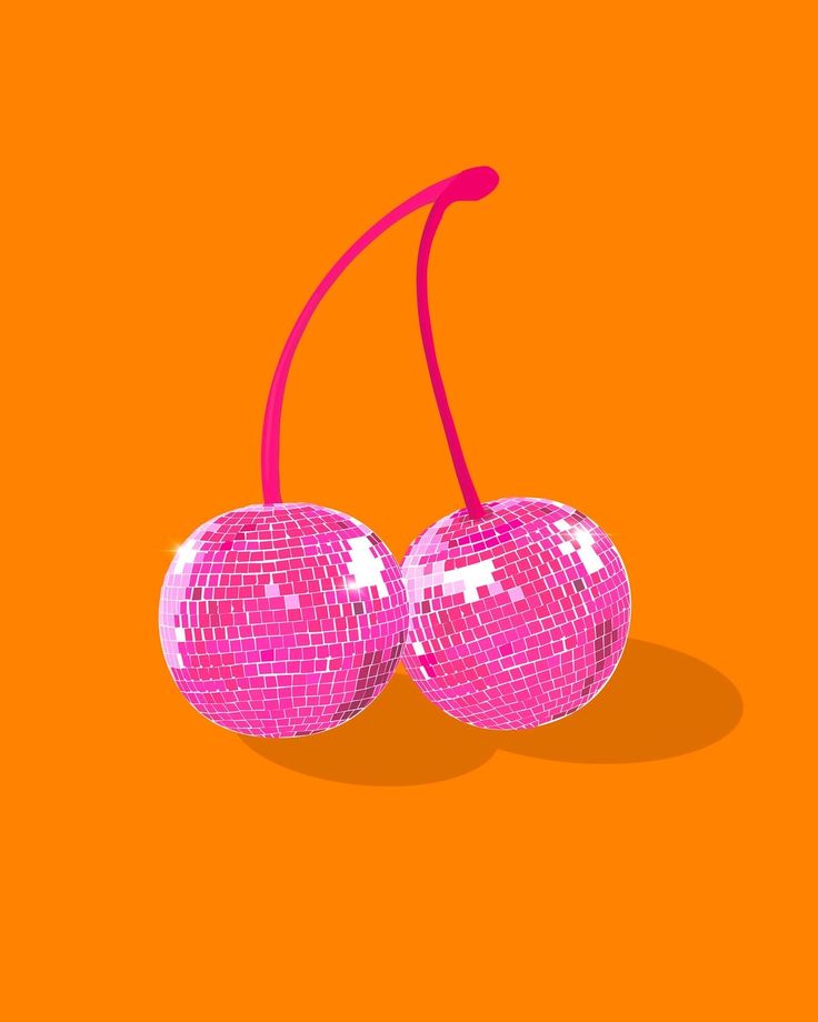 two shiny disco ball cherries on an orange background