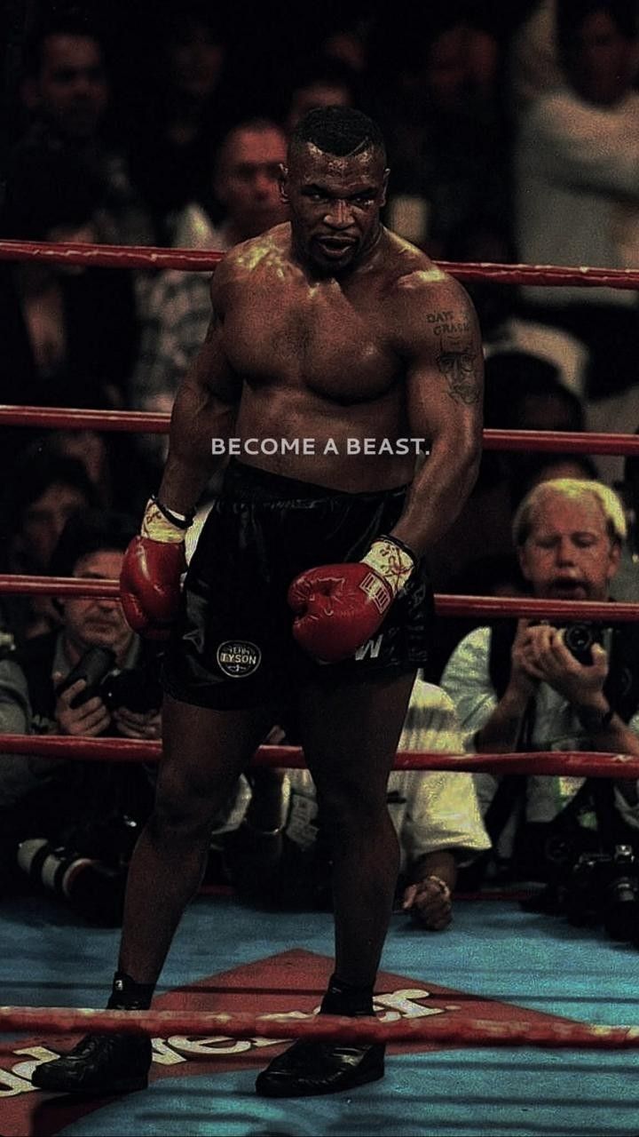 a man standing in the middle of a boxing ring