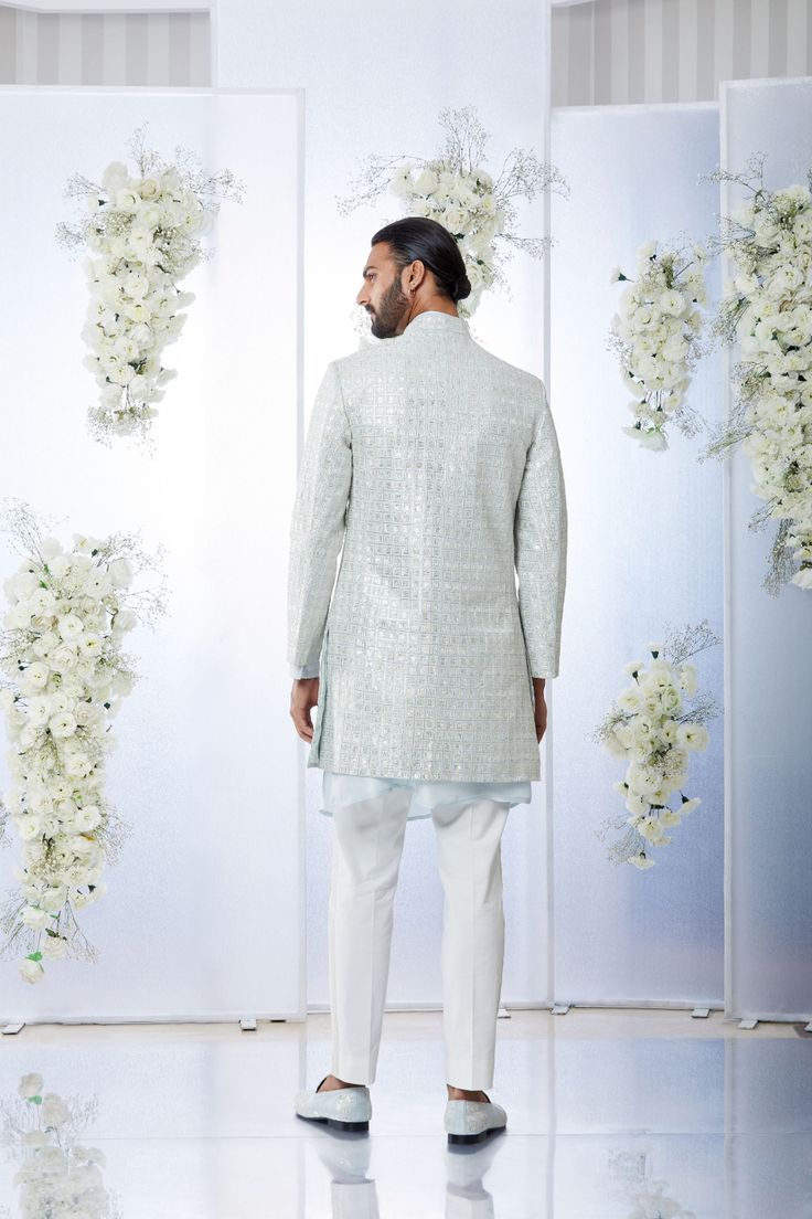 This sherwani set features all over gota embroidery on a powder blue raw silk base. It is paired with a matching silk kurta and an off-white cotton trouser. Completing footwear is also available.From Seema Gujral's Tuscan Summer collection. DELIVERY TIMEPlease allow 4 months for your outfit to arrive.FABRIC DETAILSRaw SilkProfessional cleaning only. Eid Raw Silk Nehru Jacket With Mirror Work, Eid Nehru Jacket With Mirror Work In Raw Silk, Eid Nehru Jacket In Raw Silk With Mirror Work, Designer Festive Kurta With Gota Work, Designer Gota Work Kurta For Eid, Blue Sherwani With Gota Work, Designer Festive Nehru Jacket With Gota Work, Designer Blue Sherwani With Gota Work, Festive Bandhgala With Gota Work For Reception