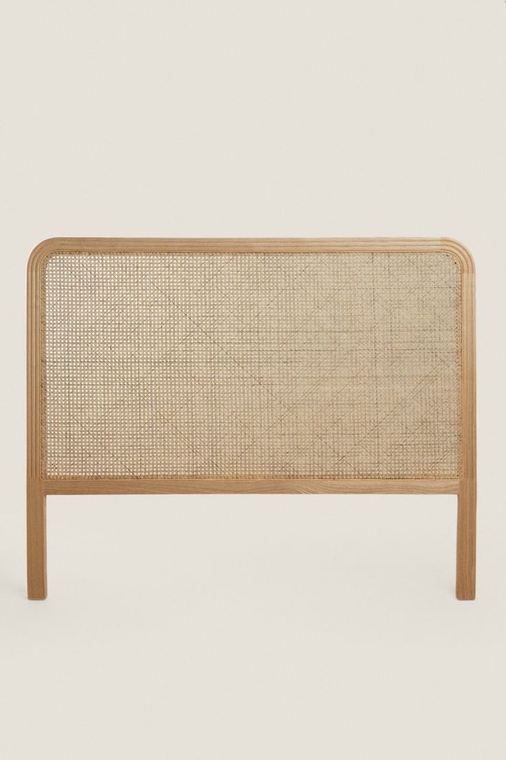 the headboard is made out of wood and has a woven fabric covering on it