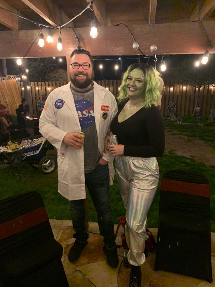 a man and woman dressed up in costumes standing next to each other on a patio