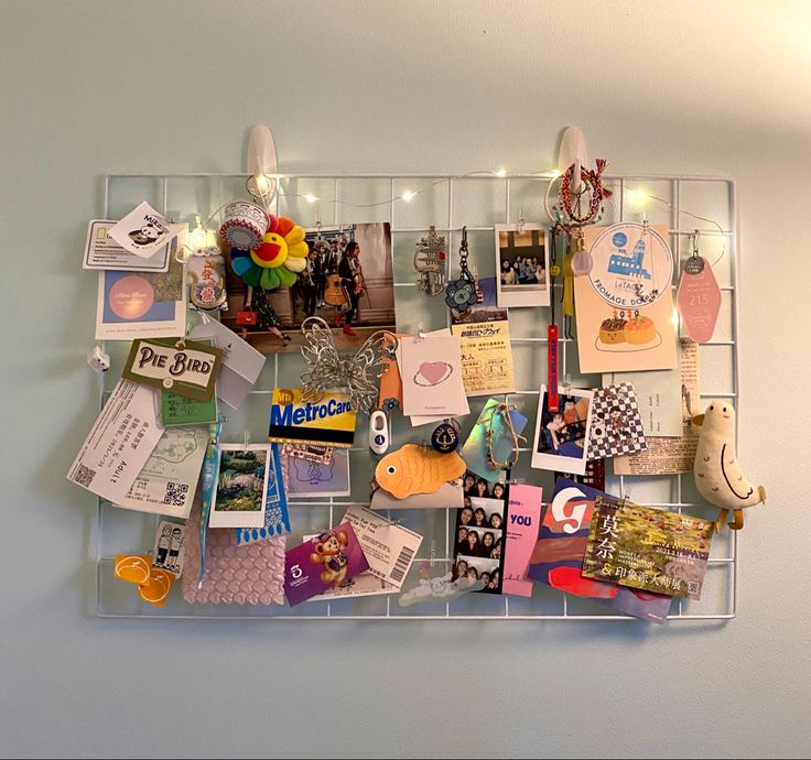 there is a wall display with many different things on the wall, including cards and magnets