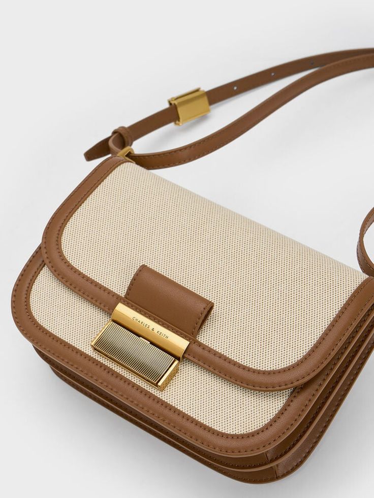 This product is made with at least 20% sustainable materials by weight. CHARLES & KEITH uses recycled, degradable, organic, and water-based materials in our eco-conscious collection. From the match-all canvas finish to the brown trim, this neutral-toned canvas version of our beloved Charlot crossbody bag is set to join the ranks of covetable wardrobe staples you'll want to to use on repeat. Featuring a classic boxy silhouette with chic curved corners, this bag's minimalist design will make matching it with outfits a breeze. Opening up into a spacious interior for all your daily essentials, this bag is as functional as it is stylish. Hermes 2024, Charles And Keith Bags, Handbag Ideas, My Style Bags, Brown Crossbody Bag, Favorite Handbags, Fancy Bags, Canvas Crossbody Bag, Charles Keith