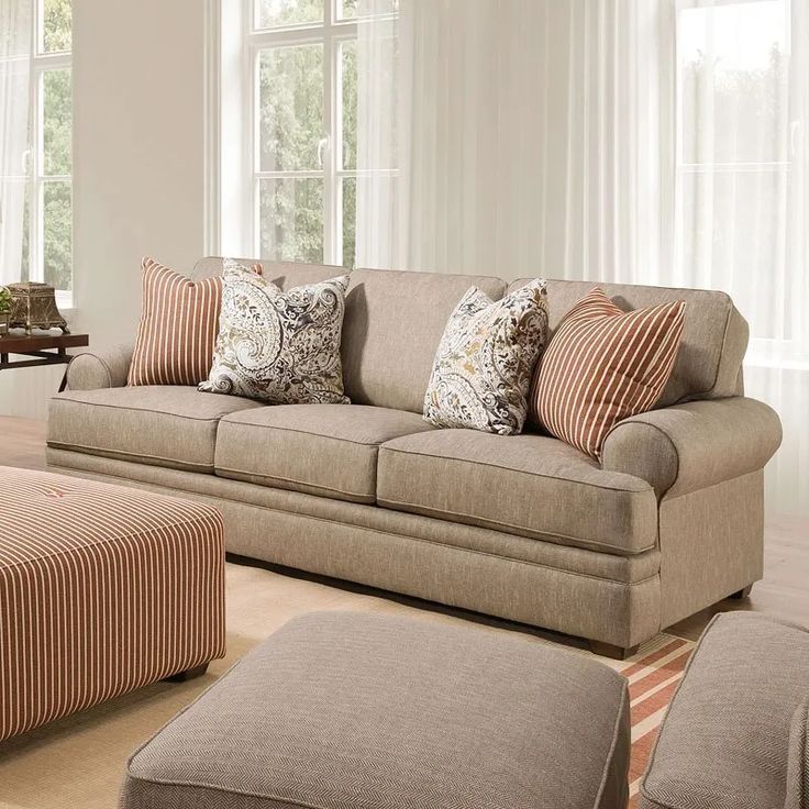 a living room filled with furniture and pillows