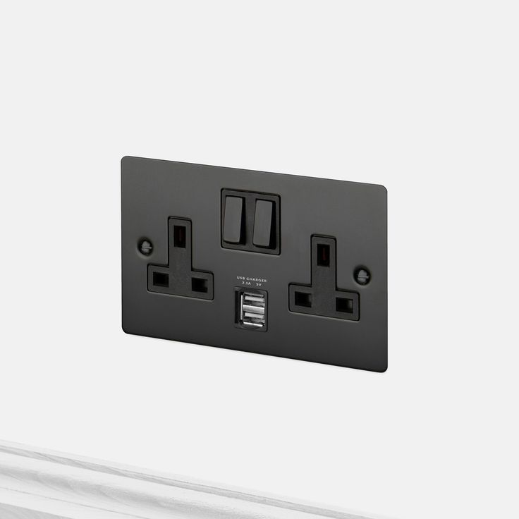 an electrical outlet with two black outlets