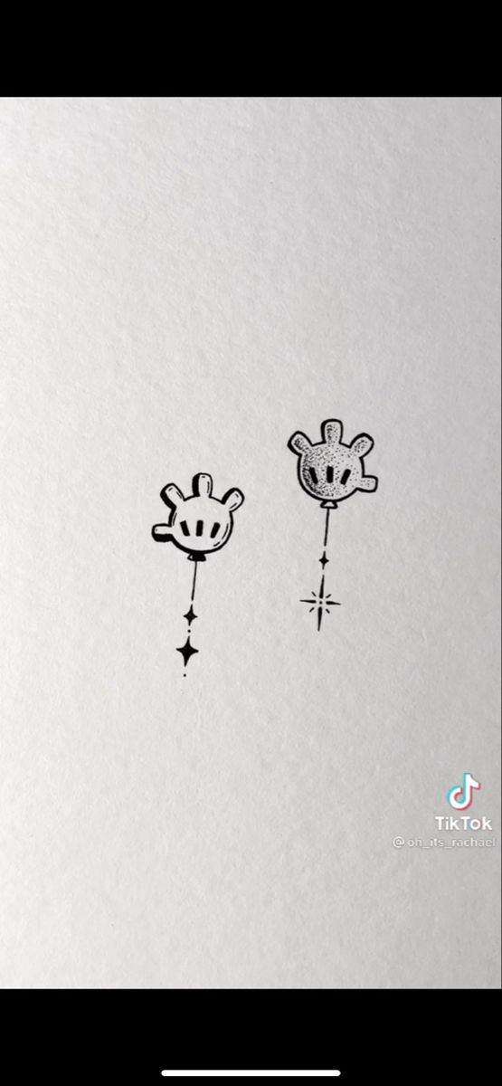 two giraffes are drawn on the side of a white paper with black ink