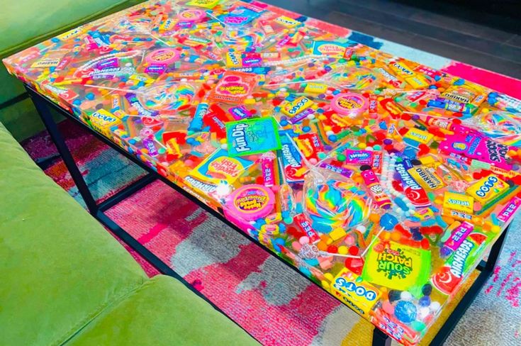 a brightly colored coffee table with lots of candies on it