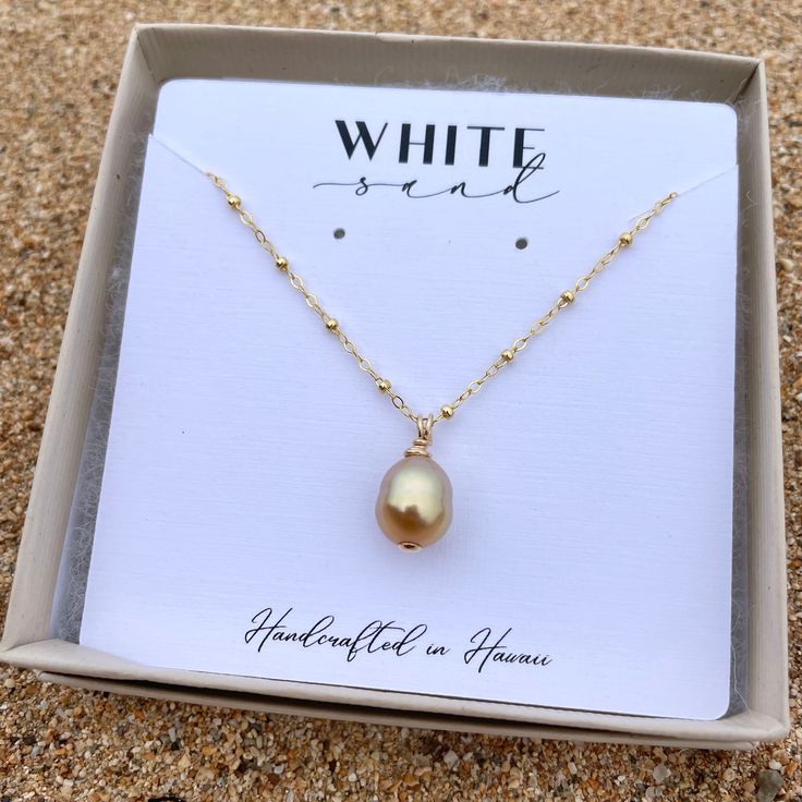 This necklace features a gorgeous drop shaped Golden South Sea Pearl on a 14K gold filled satellite chain. PLEASE NOTE: The genuine Golden South Sea Pearls will vary in shape, size and color and will have natural occurring birthmarks. The pearls will range and measure from 9mm to 10mm. These are stock photos, the necklace you receive will be similar but different. Golden South Sea Pearls are among the rarest and most sought-after pearls. Their warm, golden colors are completely natural and produ Teardrop Pearl Pendant Necklace In 14k Gold Filled, 14k Gold-filled Teardrop Pearl Pendant Necklace, Teardrop Pearl Charm Necklace In 14k Gold Filled, 14k Gold-filled Teardrop Necklace With Pearl Charm, 14k Gold Filled Teardrop Necklace With Pearl Charm, Gold Briolette Drop Necklace As Gift, Gold Briolette Drop Necklace For Gift, White 14k Gold Filled Teardrop Necklace, Gift 14k Gold Filled Pearl Drop Necklace