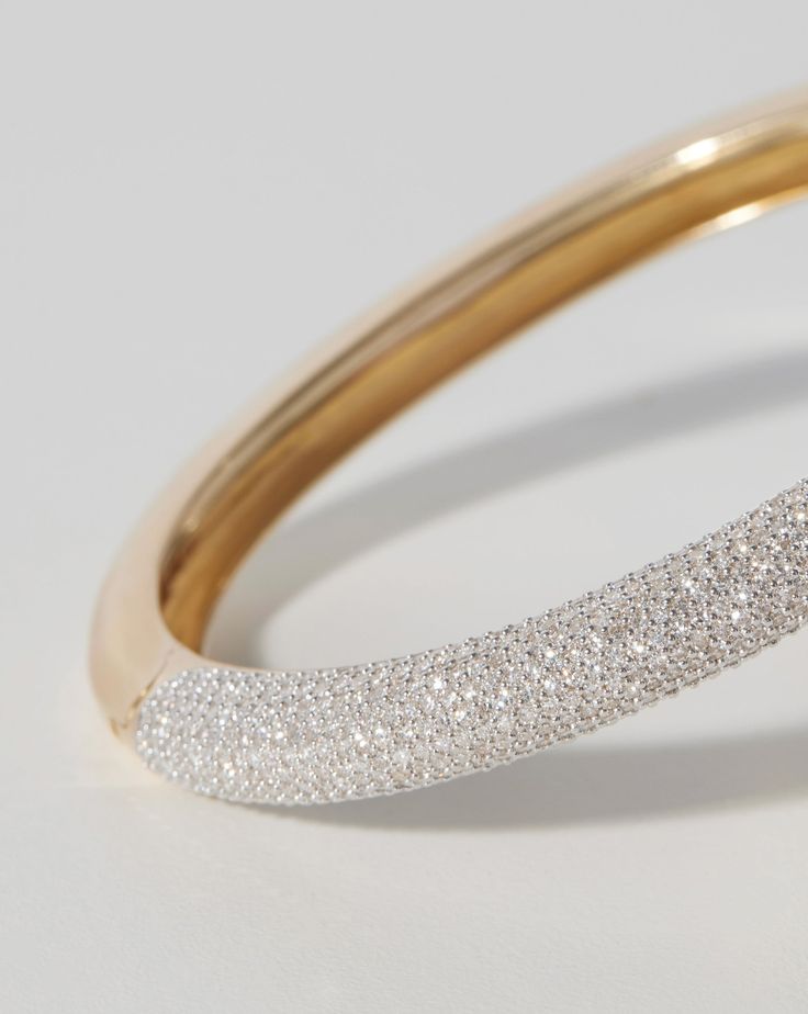 Classic: 14k solid gold 809 round, natural diamonds: Total carat weight: approximately 3.99 Color: G-H Clarity: SI Diamond coverage: halfway around bangle Width: 6 mm Oval, hinged bangle Push clasp closure Formal 14k Gold Diamond Bangle Bracelet, 14k Gold Bangle With Diamond Accents For Everyday Luxury, Dazzling Bangle With Pave Setting, 14k Gold Brilliant Cut Bangle Fine Jewelry, Dazzling Diamond Bangle Bracelet With Pave Setting, Classic Diamond Bracelet With Sparkling Detail, White Gold Round Bangle For Everyday Luxury, 14k Gold Bangle With Vvs Clarity, Diamond White Diamond Bangle With Pave Setting