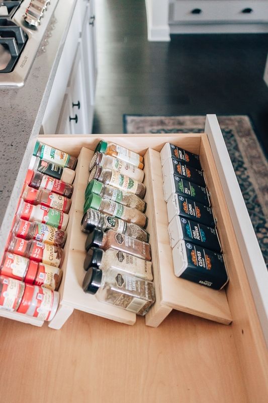 an organized kitchen drawer with spices, condiments and seasonings in the drawers