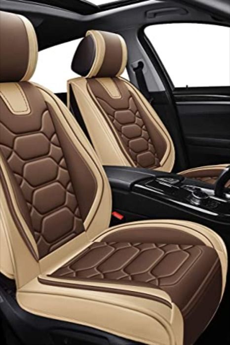 the interior of a car with brown and tan leather trimmings, including steering wheel covers