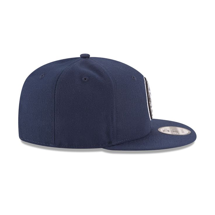 The Dallas Mavericks 9FIFTY Snapback features an allover team colored fabrication with an embroidered Mavericks logo at the front panels and an embroidered NBA logo at the rear above an adjustable snapback closure. Collegiate Navy Baseball Cap With Flat Bill, Navy Snapback Hat With Embroidered Logo, Flat Brim Hats With Logo Patch For Game Day, Collegiate Six-panel Snapback Hat With Embroidered Logo, Navy Snapback Baseball Cap With Embroidered Logo, Navy Snapback Baseball Cap For Baseball Season, Navy Snapback Hat For Game Day, Game Day Flat Bill Hat With Logo Patch, Team-colored Flat Bill Trucker Hat For Streetwear