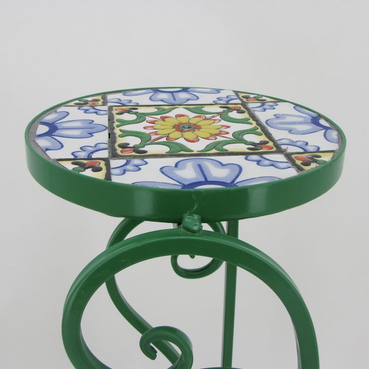 a green table with a flower design on it