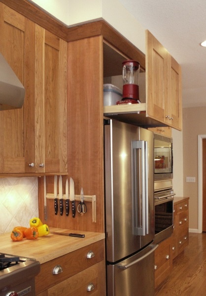 a kitchen with wooden cabinets and stainless steel appliances