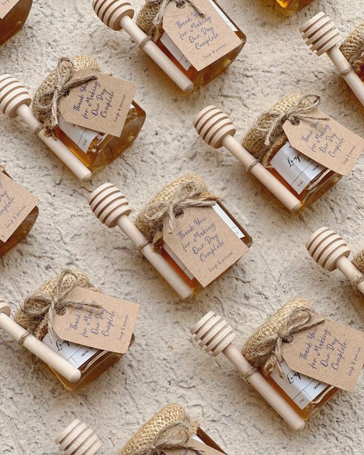 several honey jars with tags tied to them