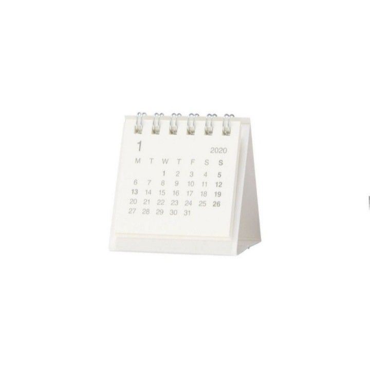 a white calendar sitting on top of a desk next to a pen and paper holder