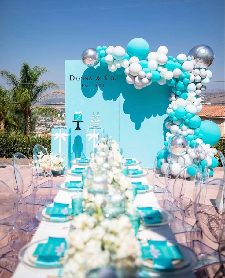 a table set up with blue and white decorations