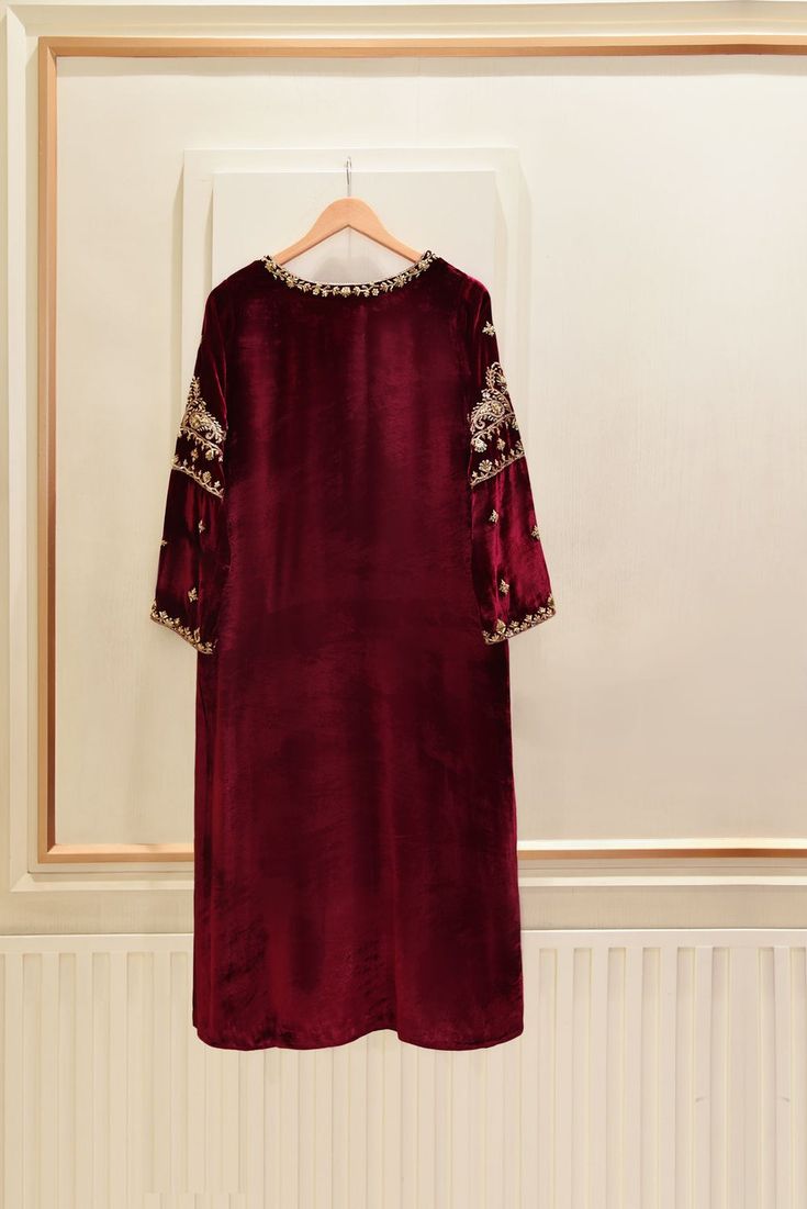 A heavily embellished beautiful three piece on pure burgundy velvet, adorned with the most stunning hand/ada work of dabka, naqshi, sequins and crystals done by our skilled artisans. Paired with a matching pure velvet shawl and flappers featuring intricate hand details. The length of the long Kameez is 48 inches. Agha Anarkali Sherwani With Mirror Work For Party, Elegant Red Unstitched Suit With Dabka, Hand Embellished Sharara For Formal Parties, Hand Embellished Sharara For Party Wear, Festive Anarkali Unstitched Suit Hand Embellished, Party Raw Silk Dupatta Hand Embellished, Party Dupatta In Hand-embellished Raw Silk, Formal Anarkali Salwar Kameez Hand Embellished, Red Dabka Sherwani For Designer Wear