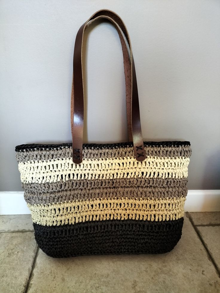 Raffia bag worn shoulders 43cm x 28cm. Colors: black beige ecru natural and brown. Leather handles. Brown Tote Satchel For Beach, Beige Double Handle Beach Bag For Shopping, Beige Satchel With Rolled Handles For Shopping, Beige Shoulder Bag With Braided Handles For Shopping, Summer Black Shoulder Bag With Handles, Neutral Crochet Bag With Braided Handles, Neutral Rectangular Crochet Bag With Braided Handles, Neutral Bags With Rolled Double Handles, Travel Shoulder Bag In Beige With Rolled Handles