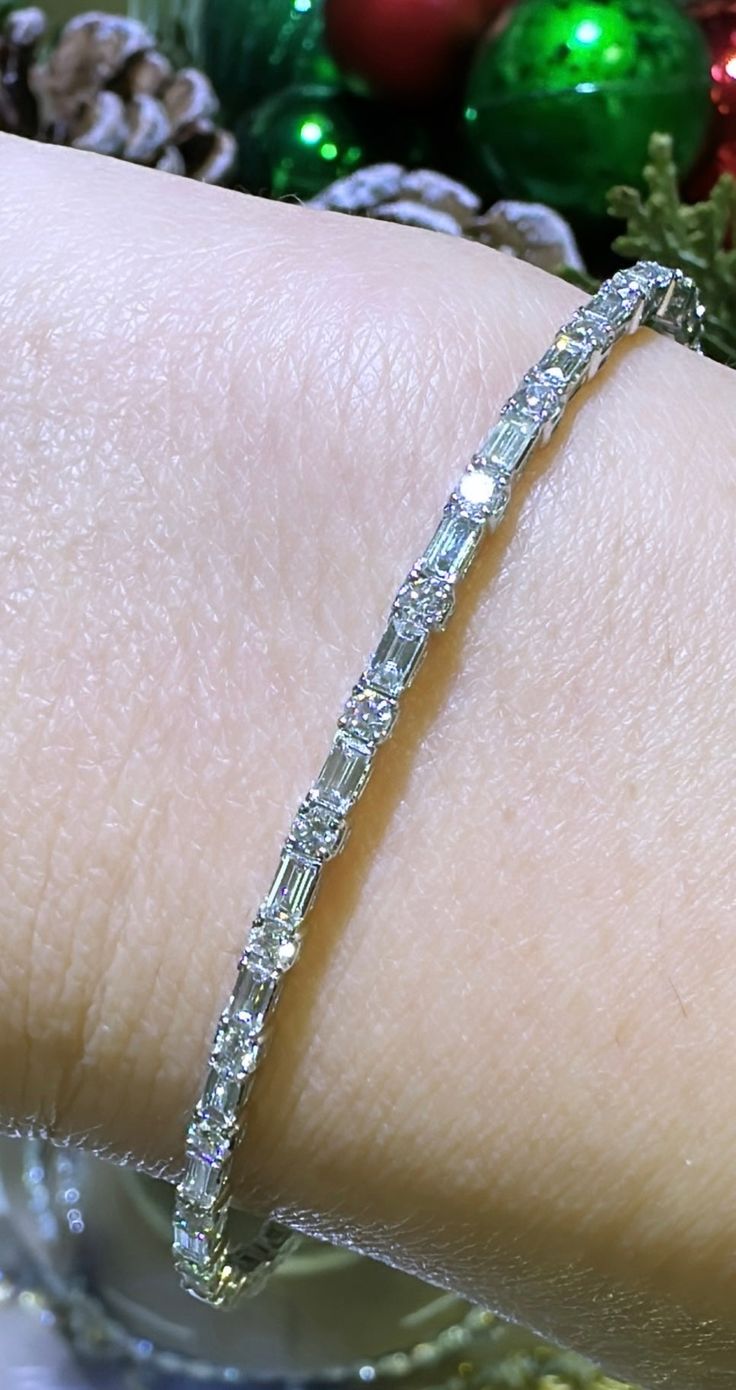 Glamour meets elegance with our 1.74ct tw diamond baguette and round alternating bracelet. Alternating diamonds in both baguette and round cuts create a stunning and unique design. Bring luxury to any outfit and make a statement with this beautiful piece. Metal: 18K White GoldDiamond Shape , Weight: (82) Round Cuts 1.89ctw, (54) Baguette Cuts 2.08ctwDiamond Total Weight: 3.97ct twBangle/Wrist Width: 53mm x 45mmBangle Width: 7mm Estimated production time is 4 - 5 weeks. Diamond Baguette, Baguette Cut, Baguette Diamond, Round Cut, Diamond Bracelet, Unique Design, Unique Designs, Diamonds, White Gold