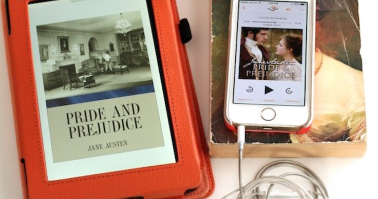 an ipod and headphones sitting next to a book on a white table with earbuds