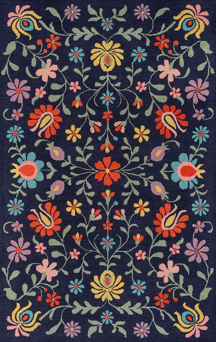 a blue rug with colorful flowers and leaves on the side, in an ornate pattern