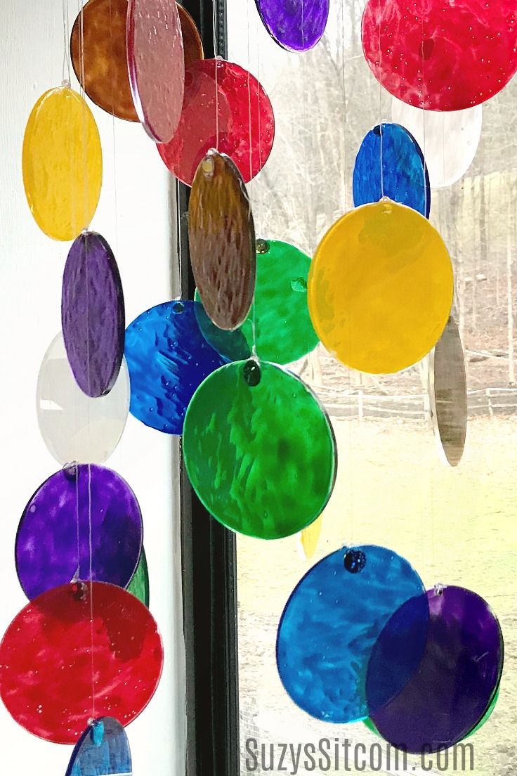 stained glass sun catcher hanging from a window with the words stained glass sun catcher on it