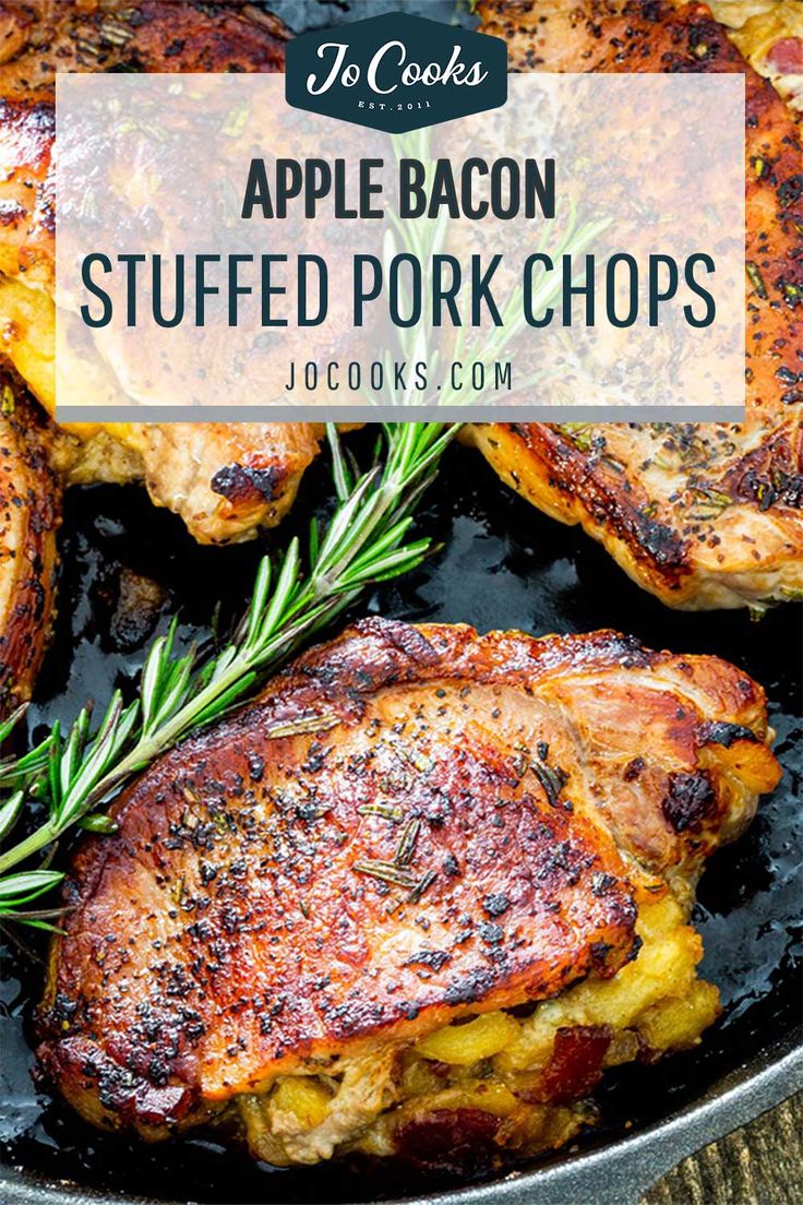 grilled pork chops in a skillet with rosemary garnish