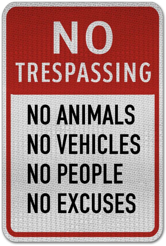 a red and white sign that says no trespassing