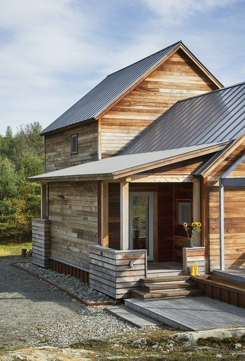 a small wooden house with a metal roof