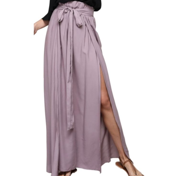 New And Unused! Make A Statement And Step Into Spring/Summer In This Gorgeous Lilac Colored Maxi Skirt! The Skirt Features Flirty Double High Slits, Elastic Waistband And Attached Waist Bow-Tie. Skirt Is Breathable And Flowy When You Walk! 100% Rayon Small Will Fit Sizes 2-4 Medium Will Fit Sizes 4-6 Flat Measurements: Small: Waist: 13.5" Medium: Waist: 14.5" Summer Relaxed Tie Waist Skirt, Summer Skirt With Tie Waist And Relaxed Fit, Summer Relaxed Skirt With Tie Waist, Flowy Maxi Skirt With Tie Waist, Summer Flowy Skirt With Tie Waist, Summer Midi Skirt With Tie Waist, Chic Wide Leg Summer Skirt, Summer Bottoms With Split Hem For Day Out, Spring Vacation Bottoms With Split Hem