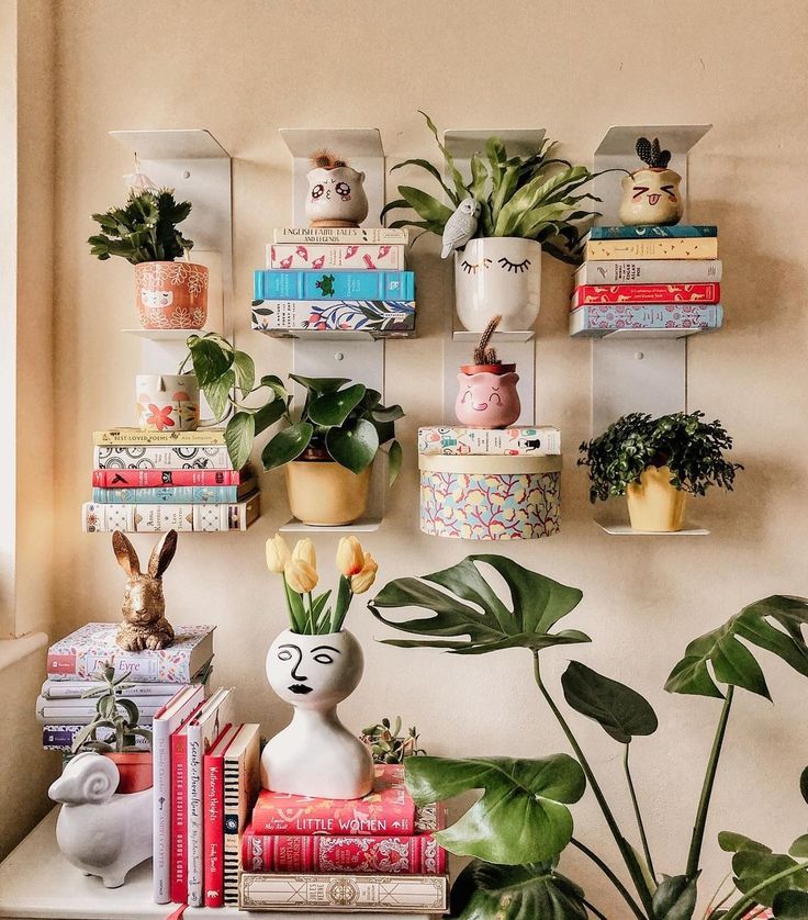 there are many plants and books on the shelf