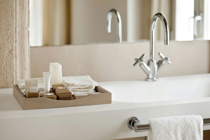 a bathroom sink with soap and toothpaste on it