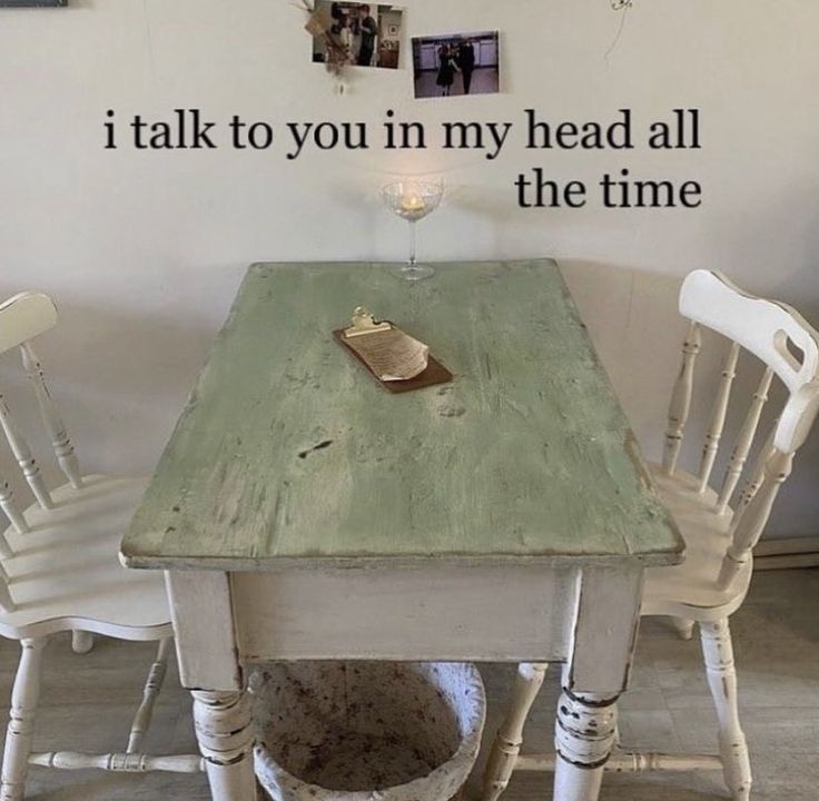 a wooden table with chairs around it and a quote on the wall above it that says, i talk to you in my head all the time