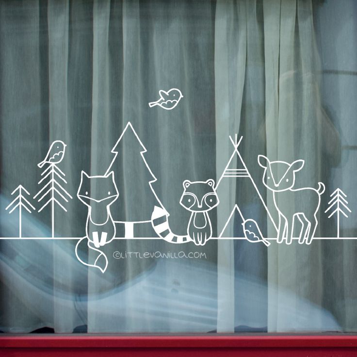 a window with some animals drawn on the glass in front of it and trees outside