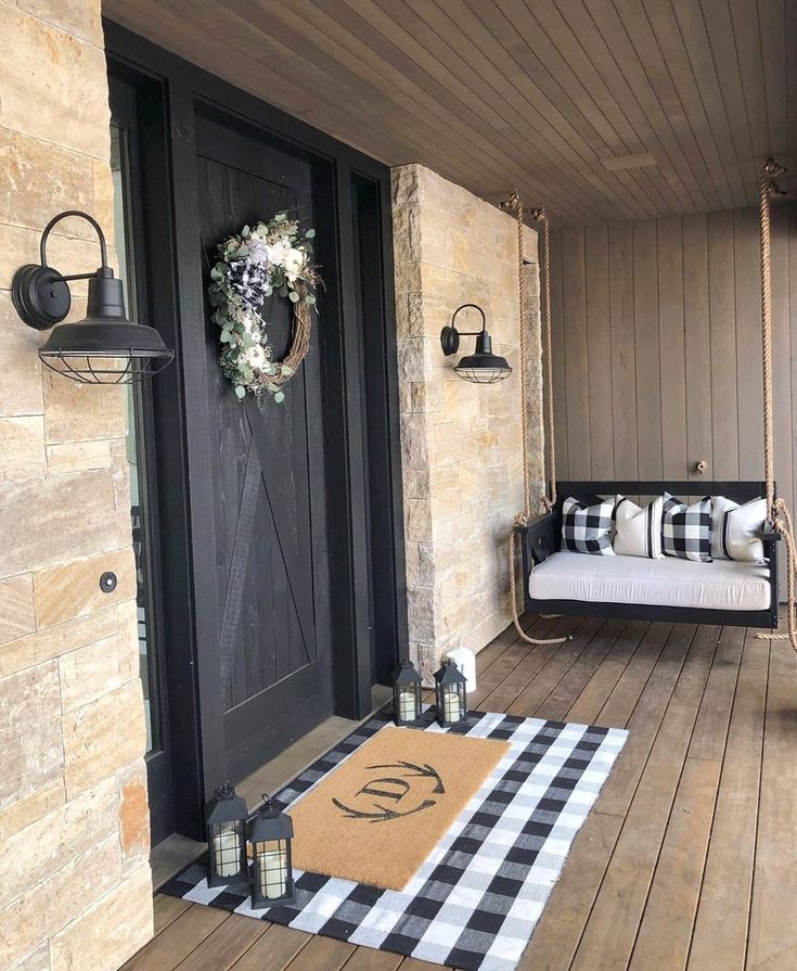 a porch decorated with black and white decor