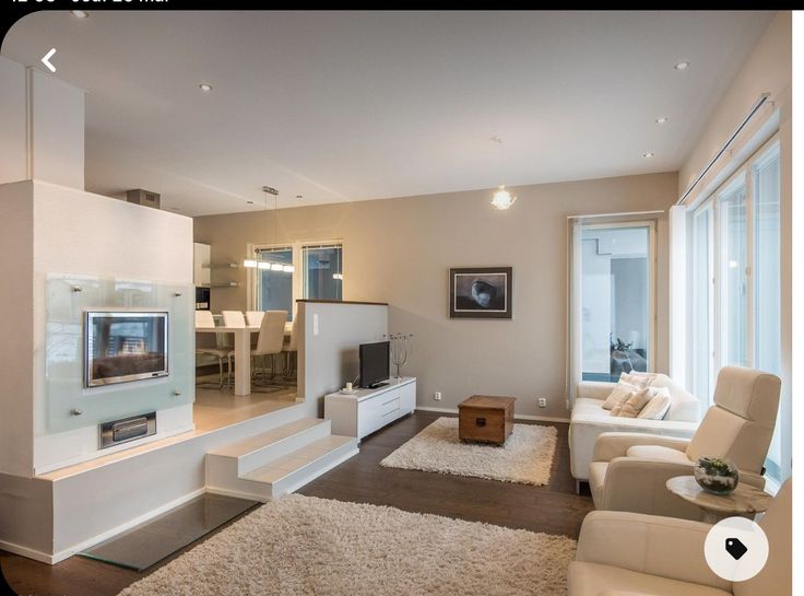 a living room filled with furniture and a flat screen tv on top of a wall