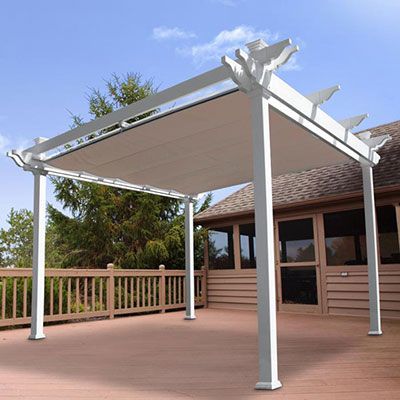 a white pergolan sitting on top of a wooden deck