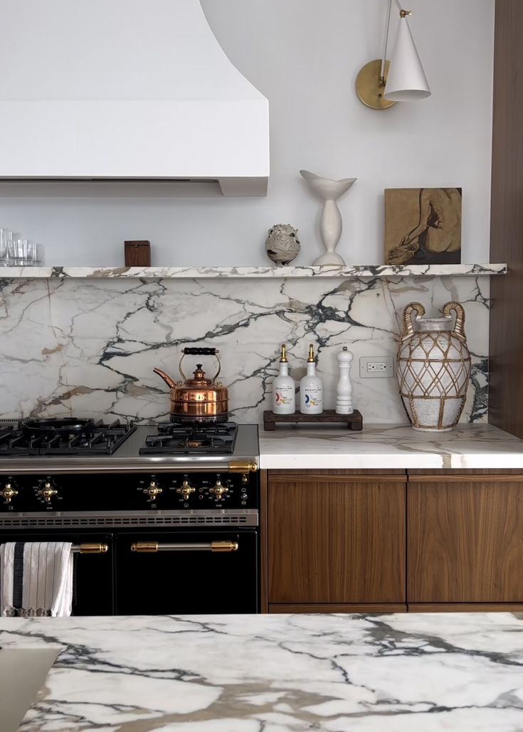 a kitchen with marble counter tops and an oven in the center, surrounded by wooden cabinets