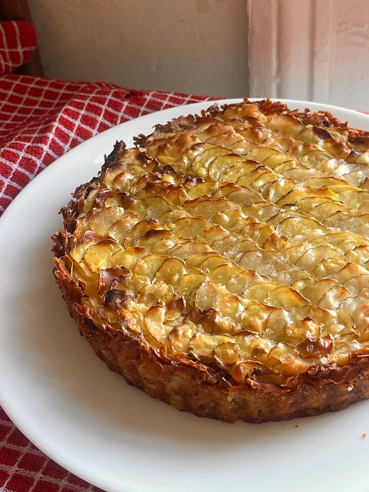 a pie sitting on top of a white plate