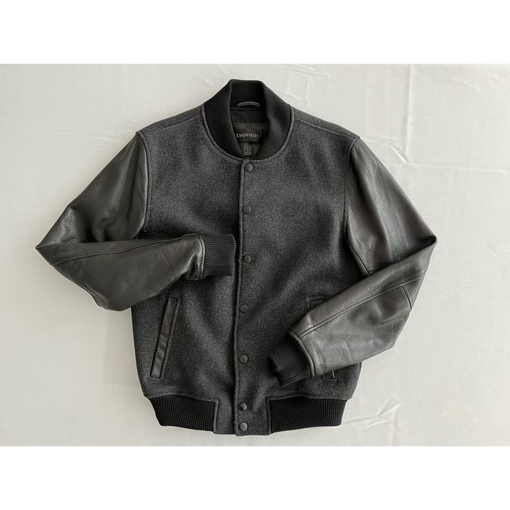 "Wool and leather bomber style jacket by Danier.   Grey wool with a black leather sleeves for a sleek tonal look. Excellent layering piece, great staple that you will have forever. Marked size small-may be mens small since it fits more like a women's medium Chest 39\" Waist 29\" Sleeve 26\" Shoulders 17.5\" Length 24.5\" 60% wool 40% polyester  genuine leather  lining 50% cotton 50% polyester Condition is excellent; shows no signs of wear" Tailored Wool Varsity Jacket For Fall, Fall Leather Jacket With Ribbed Cuffs, Urban Leather Outerwear With Ribbed Cuffs, Fitted Black Leather Jacket With Ribbed Cuffs, Black Fitted Leather Jacket With Ribbed Cuffs, Leather Outerwear With Ribbed Cuffs For Winter, Winter Leather Varsity Jacket With Ribbed Cuffs, Casual Leather Varsity Jacket With Ribbed Cuffs, Leather Varsity Jacket With Ribbed Cuffs For Winter