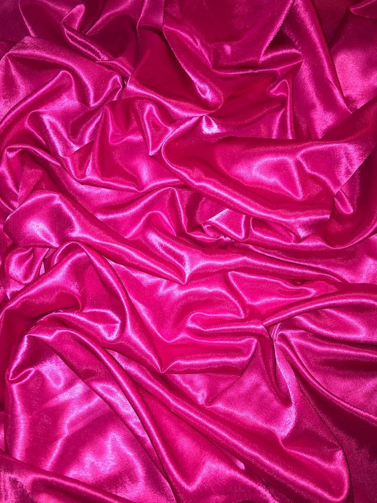 the fabric is very shiny and bright pink with some folds on it's sides