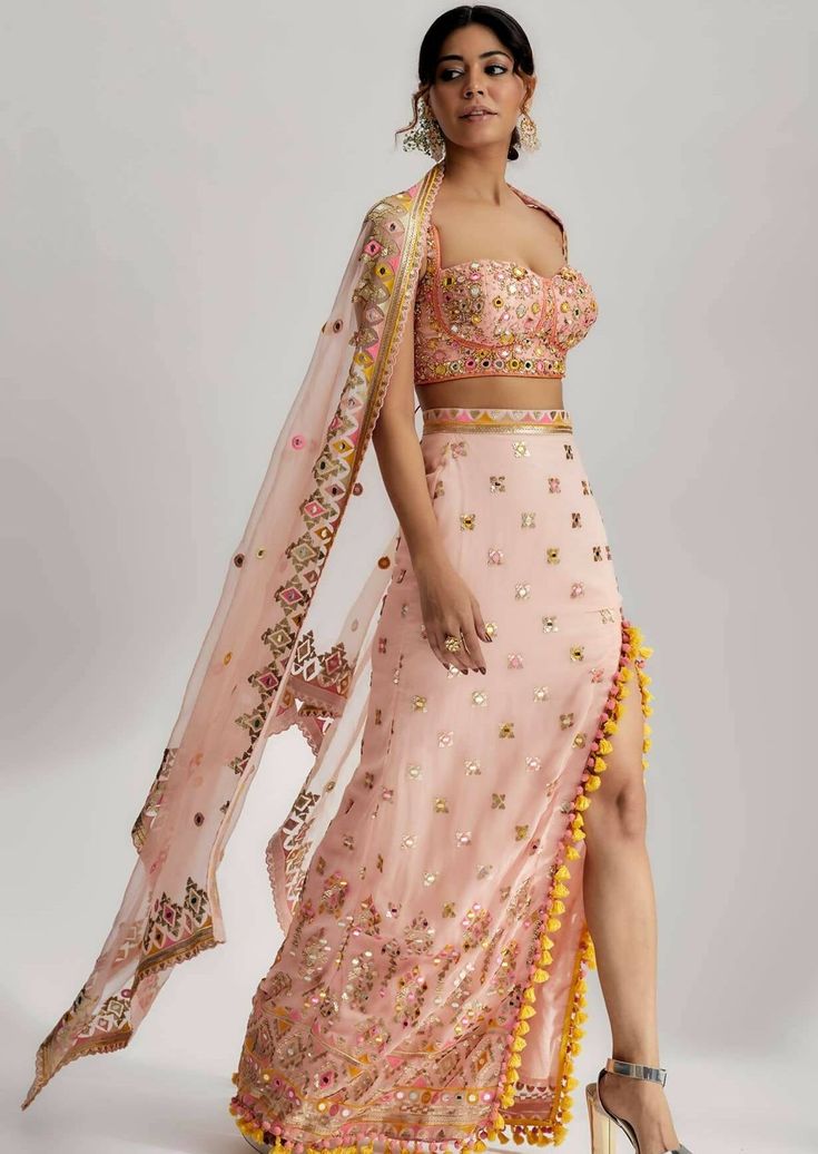 With its combination of mirror work, pompoms, tassels and detailed embroidery, the Arari Skirt Set is a showstopper that will make you the center of attention at any festive gathering. It's a celebration of tradition and contemporary style, offering a perfect blend of elegance and playfulness for a truly memorable look. Gopi Vaid, Center Of Attention, Party Wear Indian Dresses, Bridesmaid Outfit, Fringe Dress, Indian Fashion Designers, Mirror Work, Festival Dress, Western Outfits