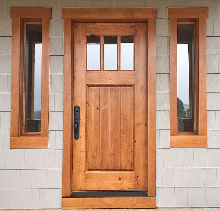 a wooden door on the side of a house