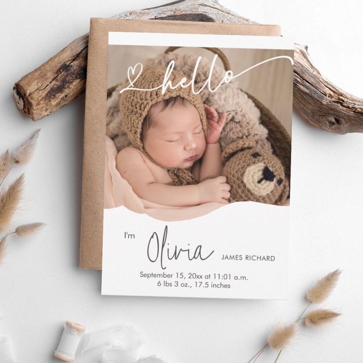 a birth announcement card with a photo of a baby in a bear hat